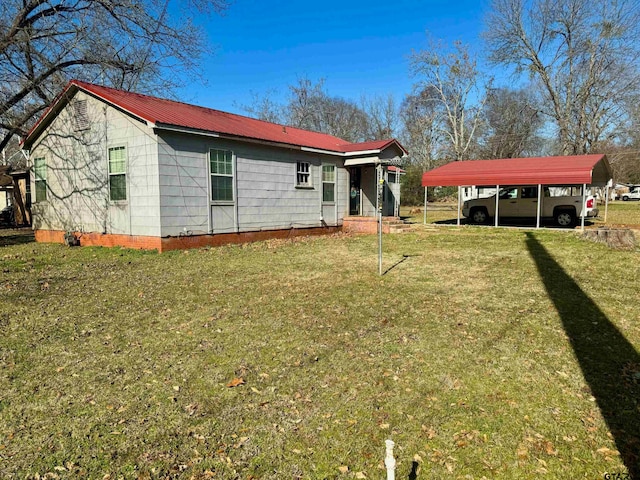 view of home's exterior featuring a lawn and a carport