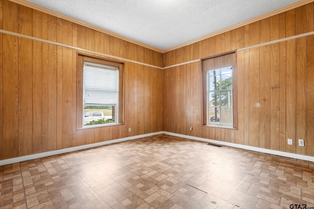 210 S Adams Ave, Tyler, TX 75702 - empty room featuring baseboards, wooden walls, brick patterned floor, and visible vents