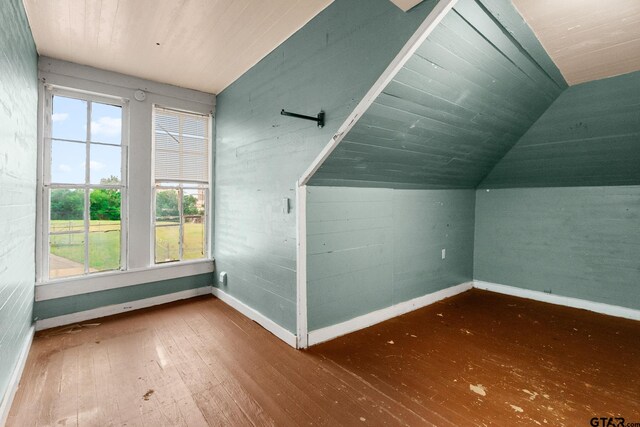 210 S Adams Ave, Tyler, TX 75702 - bonus room with lofted ceiling, wood-type flooring, and baseboards