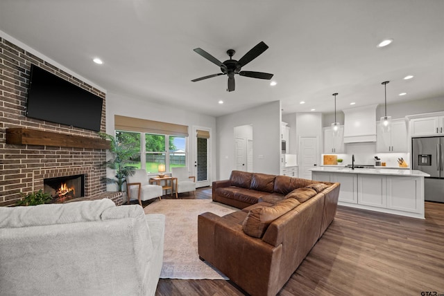 401 Deer Point Cv, Chandler, TX 75758 - living area with dark wood finished floors, a ceiling fan, a fireplace, and recessed lighting