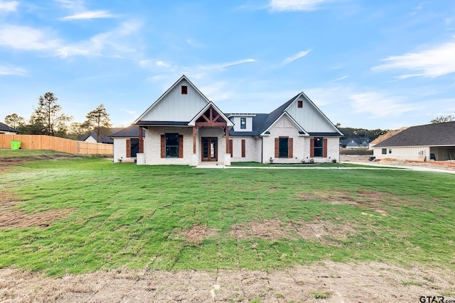 modern farmhouse style home with a front lawn