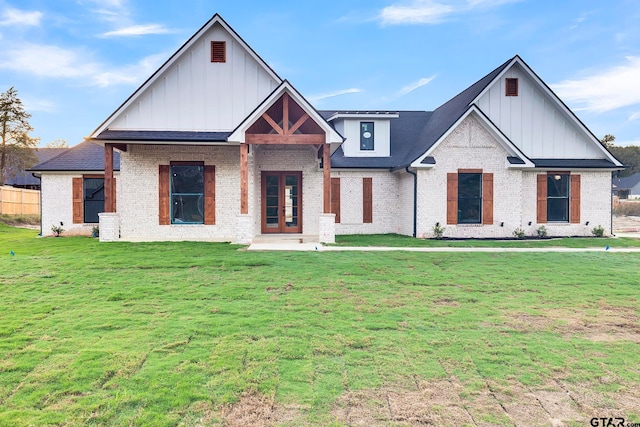 view of front facade with french doors and a front yard