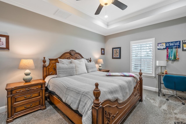 carpeted bedroom with ceiling fan, ornamental molding, and a raised ceiling