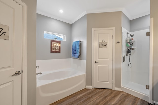 bathroom with hardwood / wood-style floors, crown molding, and independent shower and bath