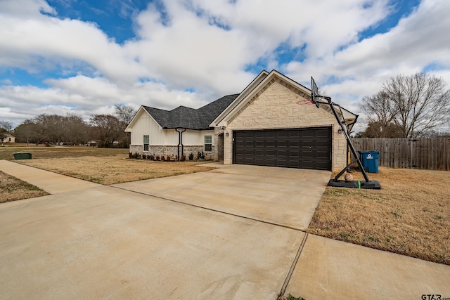 view of front of house with a garage and a front lawn