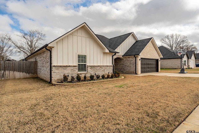 view of front of property featuring a garage and a front yard