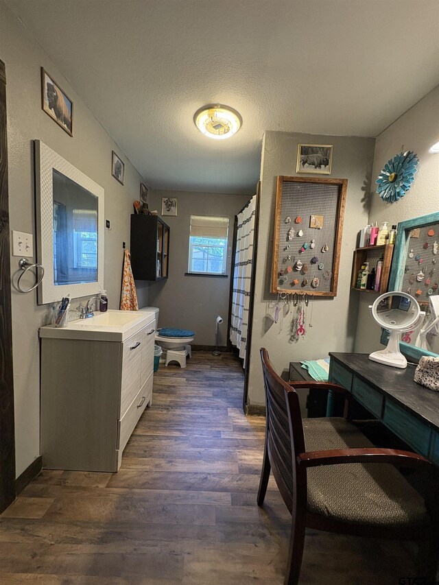 9394 Grape Ave, Frankston, TX 75763 - full bathroom with wood finished floors, vanity, baseboards, and toilet