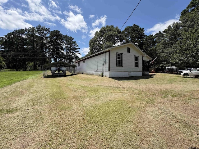 9394 Grape Ave, Frankston, TX 75763 - view of side of home featuring a carport and a lawn