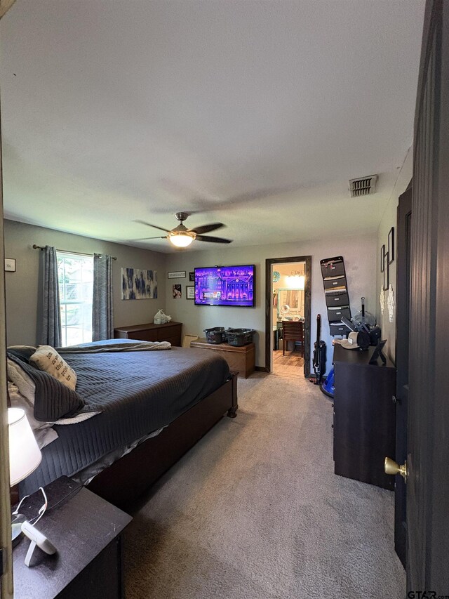 9394 Grape Ave, Frankston, TX 75763 - bedroom with carpet, a ceiling fan, and ensuite bath