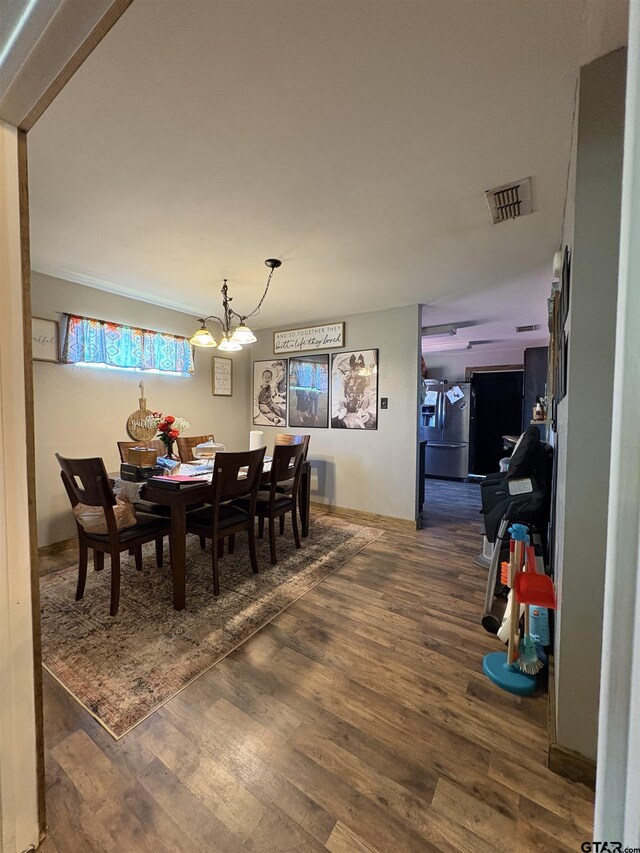 9394 Grape Ave, Frankston, TX 75763 - dining space featuring wood finished floors and a chandelier