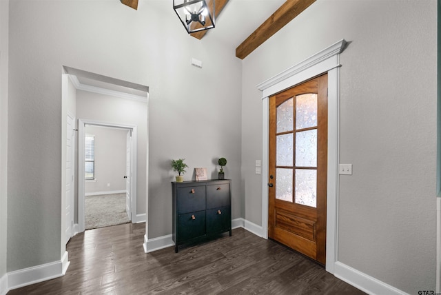 foyer entrance with dark hardwood / wood-style flooring, beamed ceiling, and a chandelier