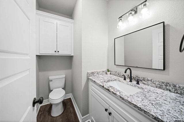 bathroom featuring hardwood / wood-style floors, vanity, and toilet