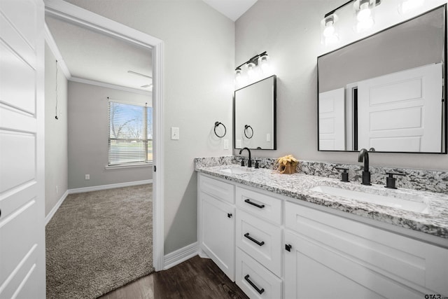 bathroom featuring hardwood / wood-style flooring, vanity, and crown molding