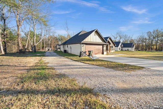 view of property exterior featuring a garage and a lawn