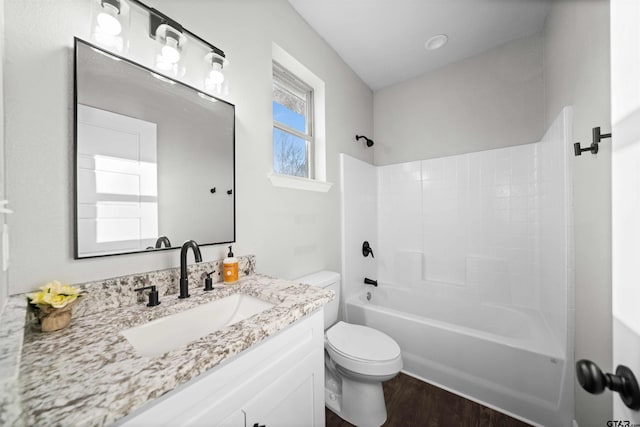 full bathroom with hardwood / wood-style floors, vanity, shower / bathtub combination, and toilet