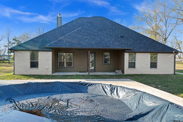 back of property featuring a covered pool and a patio area