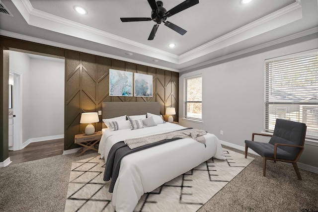 bedroom with ceiling fan, crown molding, and a tray ceiling