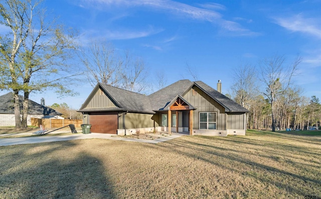 view of front of property with a garage and a front yard