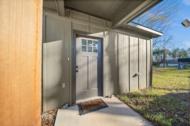 doorway to property featuring a yard