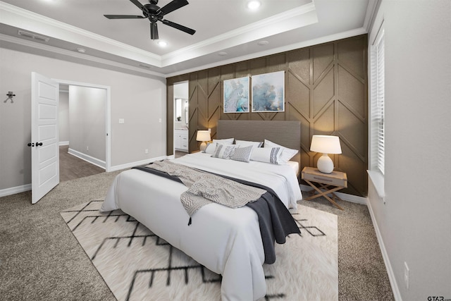 bedroom with a tray ceiling, ceiling fan, crown molding, and carpet floors