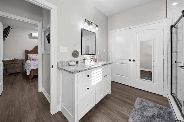 bathroom featuring hardwood / wood-style flooring, vanity, and walk in shower