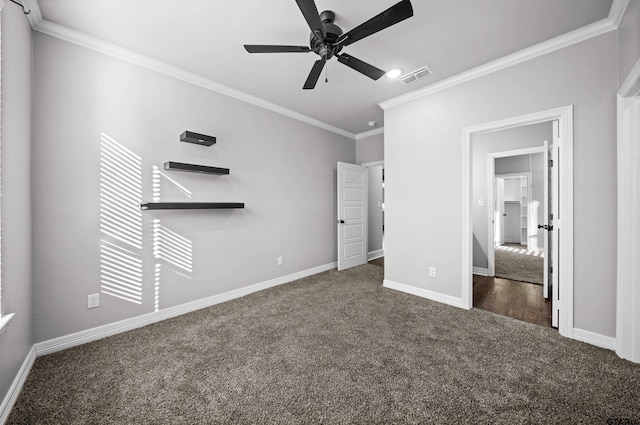 unfurnished bedroom with dark colored carpet, ceiling fan, and crown molding