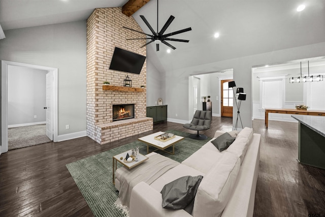 living room with beam ceiling, ceiling fan, high vaulted ceiling, dark hardwood / wood-style floors, and a fireplace