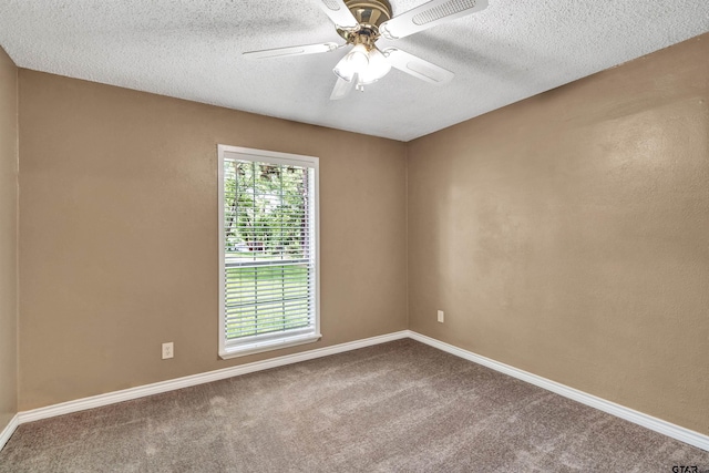 empty room featuring ceiling fan, carpet, and a textured ceiling