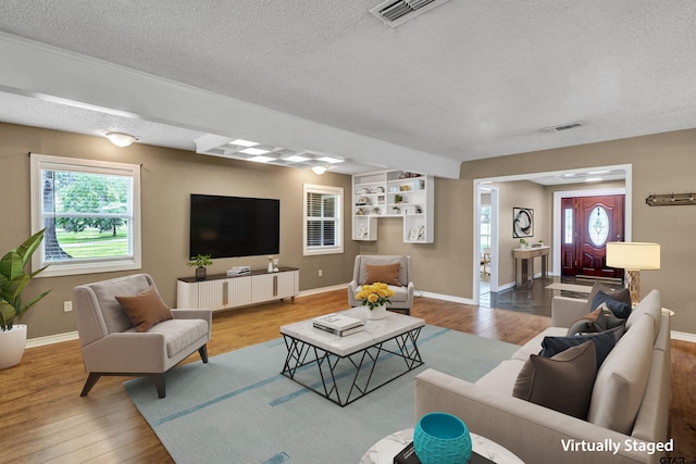 living room featuring hardwood / wood-style floors and a textured ceiling