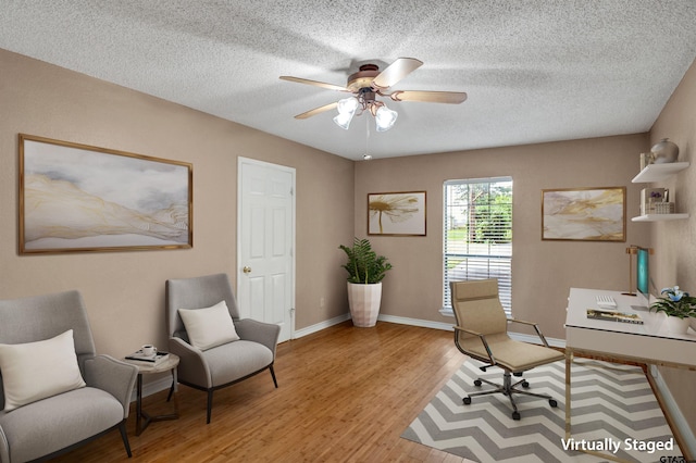 office space featuring a textured ceiling, light hardwood / wood-style flooring, and ceiling fan