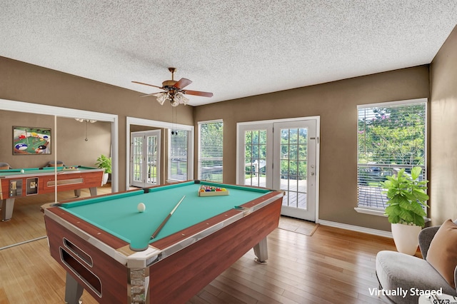 recreation room featuring ceiling fan, light wood-type flooring, a textured ceiling, and pool table