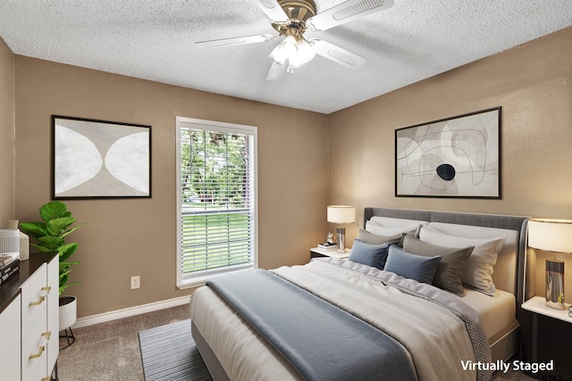 carpeted bedroom featuring a textured ceiling and ceiling fan