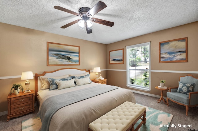 carpeted bedroom with ceiling fan and a textured ceiling