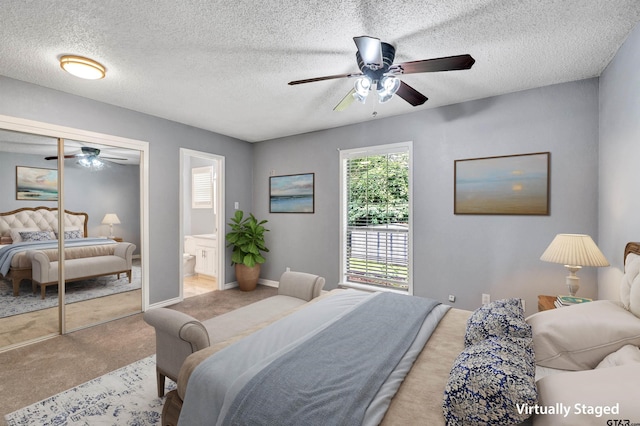 bedroom featuring a textured ceiling, a closet, ensuite bath, and ceiling fan