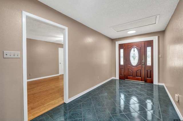 entrance foyer with dark hardwood / wood-style floors and a textured ceiling