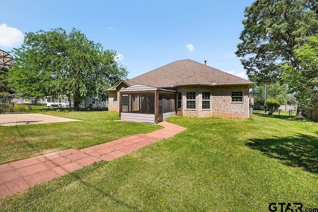 622 Martin, Chandler, TX 75758 - rear view of property with a sunroom, brick siding, and a shingled roof