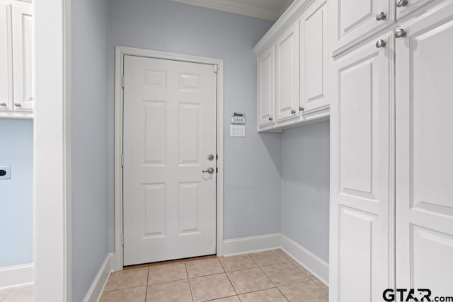 washroom with light tile patterned floors, cabinet space, baseboards, and electric dryer hookup