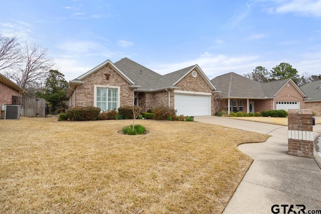 single story home featuring brick siding, central air condition unit, concrete driveway, a garage, and a front lawn