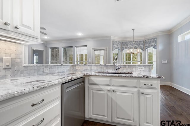 kitchen with dishwasher, tasteful backsplash, a sink, and a wealth of natural light