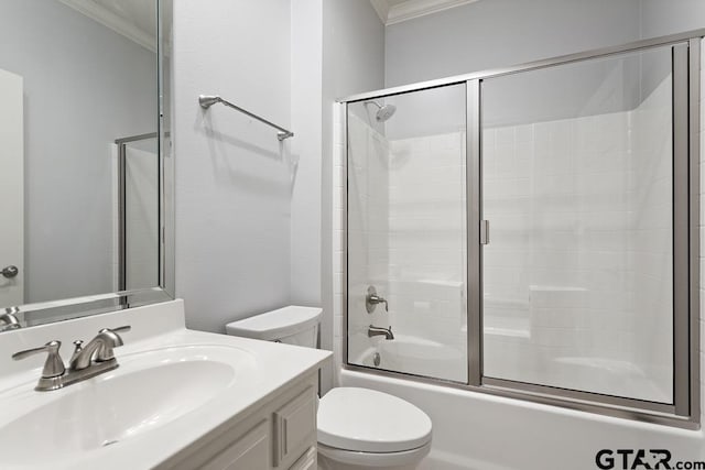 bathroom featuring vanity, toilet, and crown molding