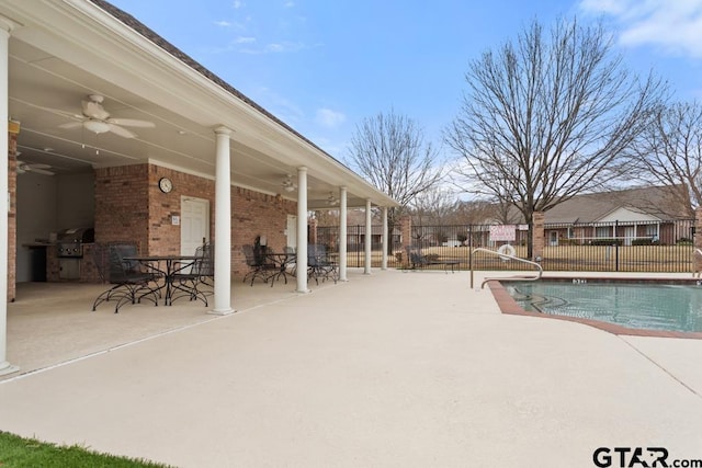 view of pool with a patio, outdoor dining space, fence, and a ceiling fan