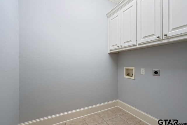 clothes washing area with washer hookup, cabinet space, hookup for an electric dryer, light tile patterned flooring, and baseboards