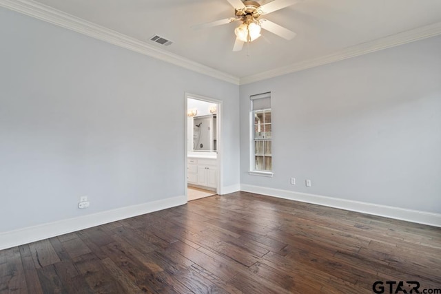 empty room with baseboards, visible vents, crown molding, and hardwood / wood-style floors