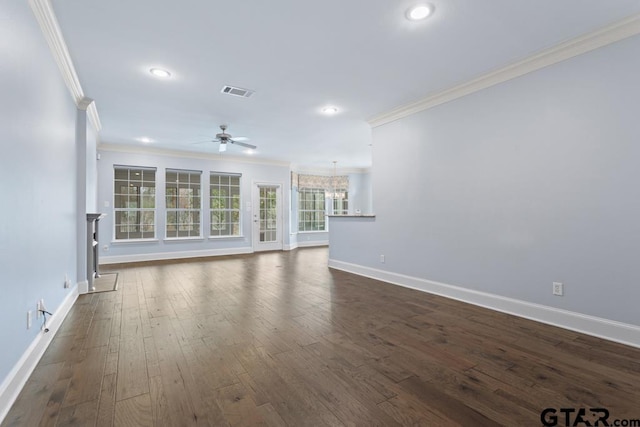 unfurnished living room with dark wood-style floors, ornamental molding, visible vents, and baseboards