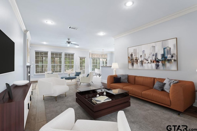 living area with baseboards, visible vents, ornamental molding, wood finished floors, and recessed lighting