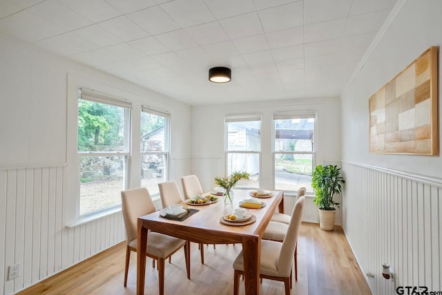 704 W 3rd St, Tyler, TX 75701 - dining space featuring healthy amount of natural light, light wood-style flooring, a wainscoted wall, and ornamental molding