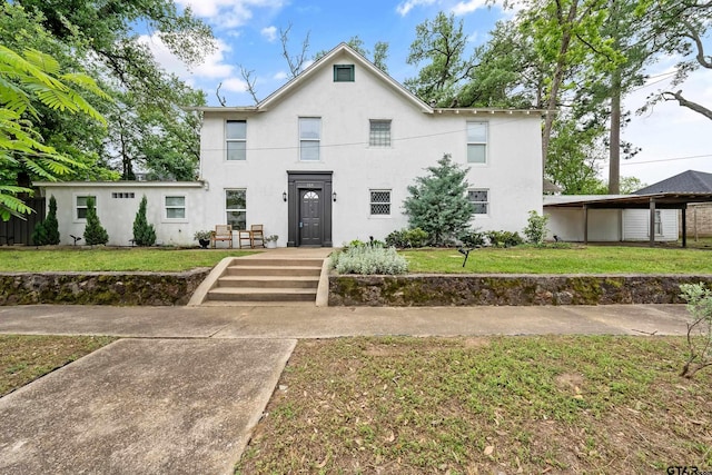 704 W 3rd St, Tyler, TX 75701 - view of front facade with stucco siding and a front yard
