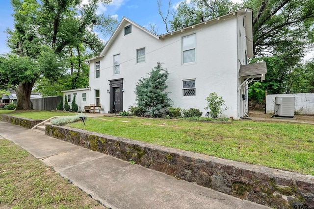 704 W 3rd St, Tyler, TX 75701 - view of front facade with central AC unit and stucco siding