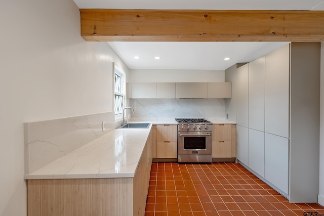 704 W 3rd St, Tyler, TX 75701 - kitchen featuring high end stove, backsplash, modern cabinets, recessed lighting, and light brown cabinetry