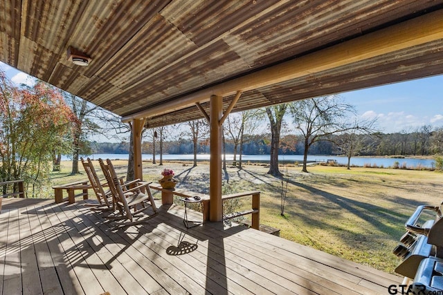 wooden deck with a water view and a yard